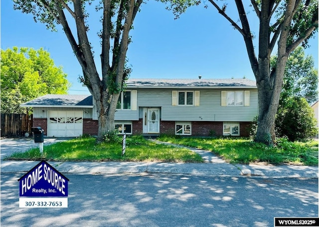 829 Belinda Dr, Riverton, WY 82520 - raised ranch featuring an attached garage and brick siding