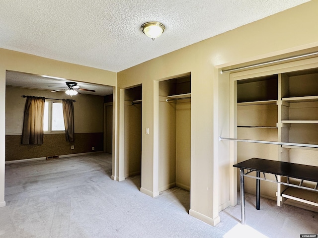 829 Belinda Dr, Riverton, WY 82520 - unfurnished bedroom featuring two closets, carpet floors, and a textured ceiling