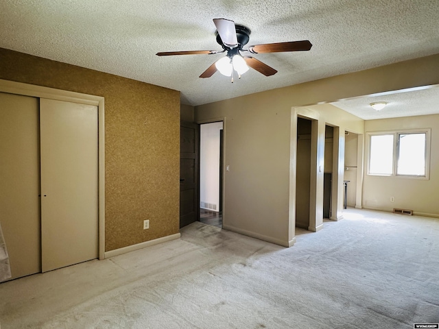 829 Belinda Dr, Riverton, WY 82520 - unfurnished bedroom featuring light colored carpet, a textured ceiling, and ceiling fan