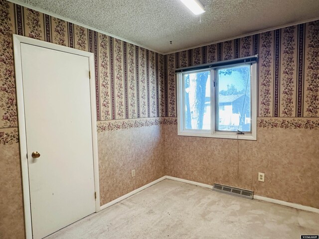 829 Belinda Dr, Riverton, WY 82520 - empty room with a textured ceiling, light carpet, and wallpapered walls