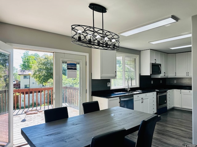 829 Belinda Dr, Riverton, WY 82520 - kitchen featuring dishwasher, stainless steel range with electric cooktop, dark countertops, and backsplash