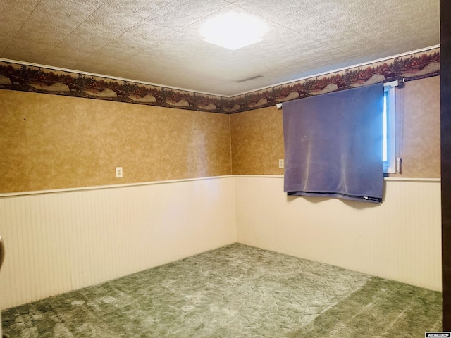 829 Belinda Dr, Riverton, WY 82520 - unfurnished room featuring a wainscoted wall and carpet flooring