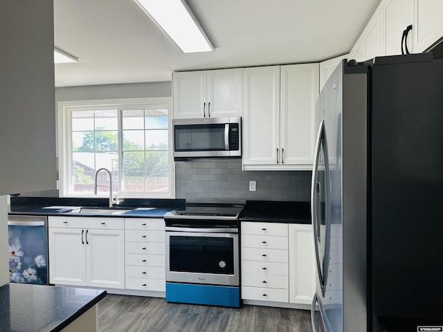 829 Belinda Dr, Riverton, WY 82520 - kitchen featuring appliances with stainless steel finishes, dark countertops, white cabinets, and dark wood-style floors