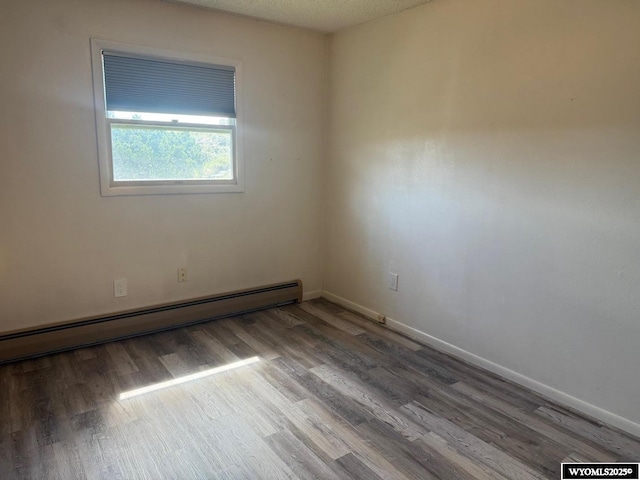1630 Coulson Dr, Rawlins, WY 82301 - unfurnished room with baseboard heating and wood finished floors