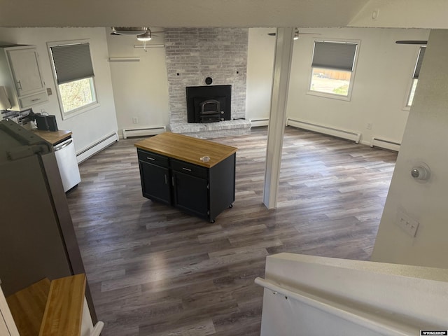 1630 Coulson Dr, Rawlins, WY 82301 - unfurnished living room featuring a baseboard radiator, baseboard heating, and dark wood-type flooring