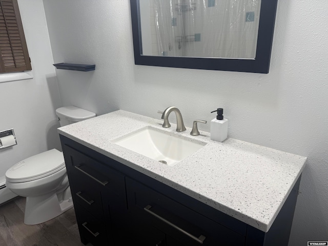 1630 Coulson Dr, Rawlins, WY 82301 - full bathroom with vanity, wood finished floors, and a shower with curtain