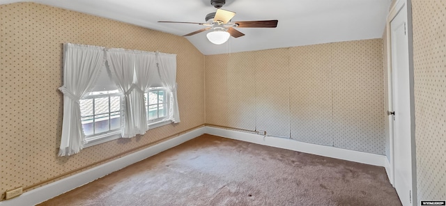 335 E 11th St, Casper, WY 82601 - carpeted empty room featuring wallpapered walls, vaulted ceiling, and a ceiling fan