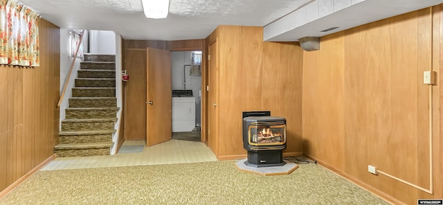 335 E 11th St, Casper, WY 82601 - finished below grade area featuring a wood stove, washer / dryer, stairs, and wooden walls