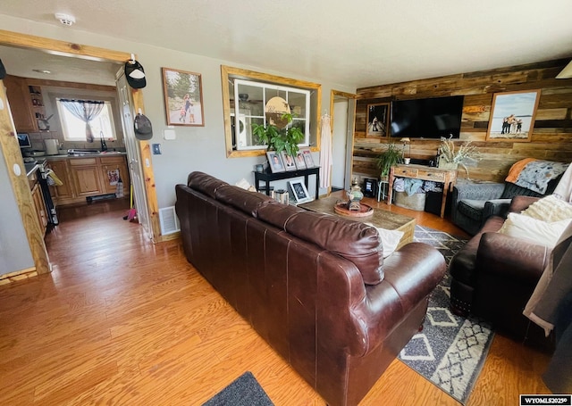1328 Canyon Ct, Kemmerer, WY 83101 - living area with light wood-type flooring and wood walls