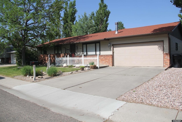 1540 Manor Dr, Casper, WY 82609 - ranch-style home featuring brick siding, a porch, an attached garage, and concrete driveway