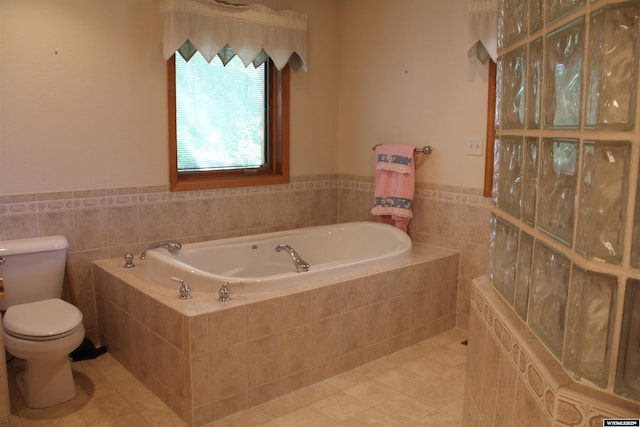 1540 Manor Dr, Casper, WY 82609 - full bathroom featuring tile patterned floors, a bath, tile walls, and a wainscoted wall