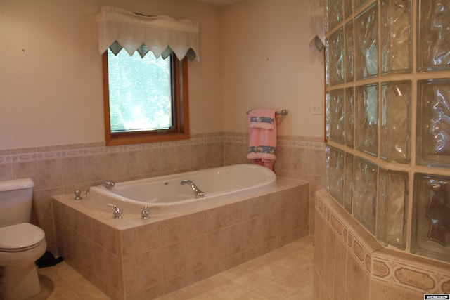 1540 Manor Dr, Casper, WY 82609 - bathroom featuring tile walls, tile patterned flooring, a garden tub, and wainscoting