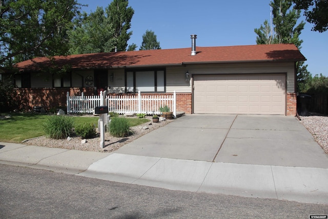 1540 Manor Dr, Casper, WY 82609 - ranch-style house featuring brick siding, concrete driveway, and a garage
