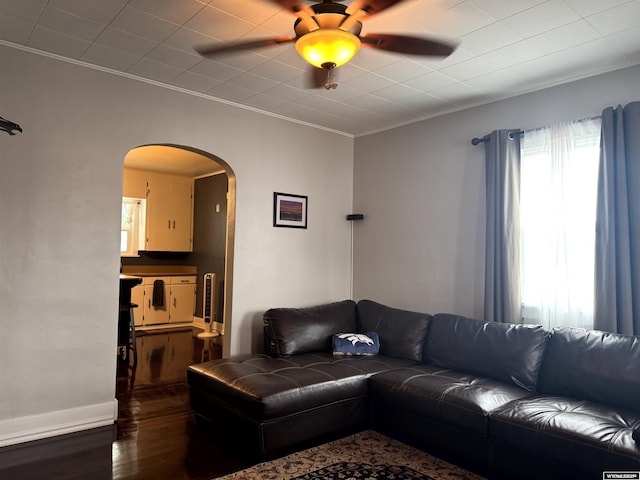 518 F St, Rock Springs, WY 82901 - living area featuring arched walkways, wood finished floors, ceiling fan, and crown molding