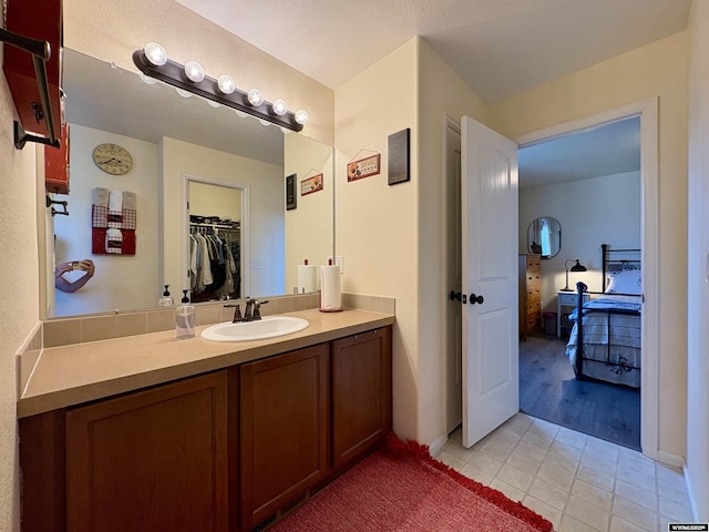 1261 Meadow Ln, Douglas, WY 82633 - bathroom with tile patterned flooring, vanity, and a walk in closet