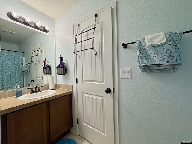 1261 Meadow Ln, Douglas, WY 82633 - bathroom with vanity, tile patterned flooring, and a textured wall