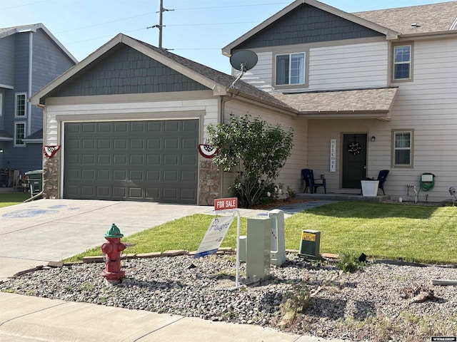 1261 Meadow Ln, Douglas, WY 82633 - craftsman house with an attached garage, driveway, a front yard, stone siding, and roof with shingles
