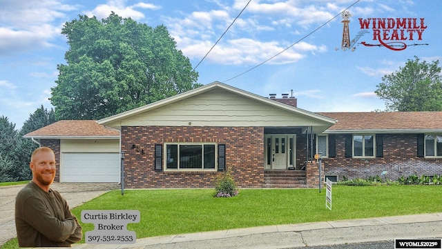 918 E 27th Ave, Torrington, WY 82240 - ranch-style home with brick siding, a front yard, a garage, and concrete driveway