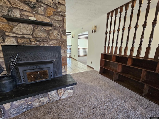 918 E 27th Ave, Torrington, WY 82240 - unfurnished living room with a textured ceiling, carpet floors, tile patterned flooring, and a fireplace