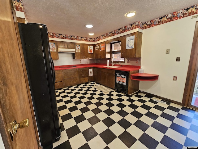 918 E 27th Ave, Torrington, WY 82240 - kitchen featuring black appliances, light floors, a textured ceiling, under cabinet range hood, and recessed lighting