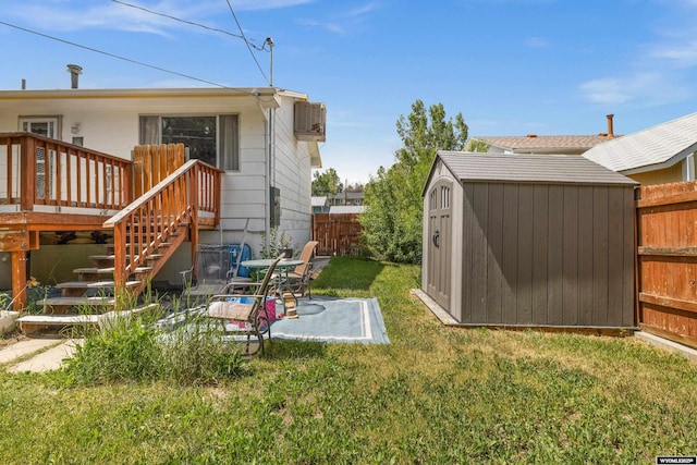 1831 Glendale Ave, Casper, WY 82601 - fenced backyard with a storage unit, a wooden deck, and stairs