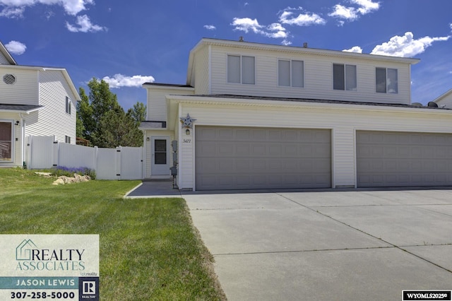 3477 Trappers Trl, Casper, WY 82604 - traditional home featuring concrete driveway, a garage, and a gate