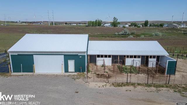 7459 Geary Dome Rd, Evansville, WY 82636 - view of front of home featuring an outbuilding, an exterior structure, a metal roof, and a detached garage