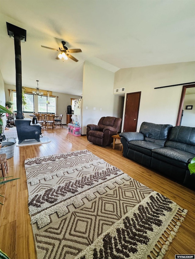 1512 Highview Dr, Dubois, WY 82513 - living room with lofted ceiling, a ceiling fan, wood finished floors, and a wood stove