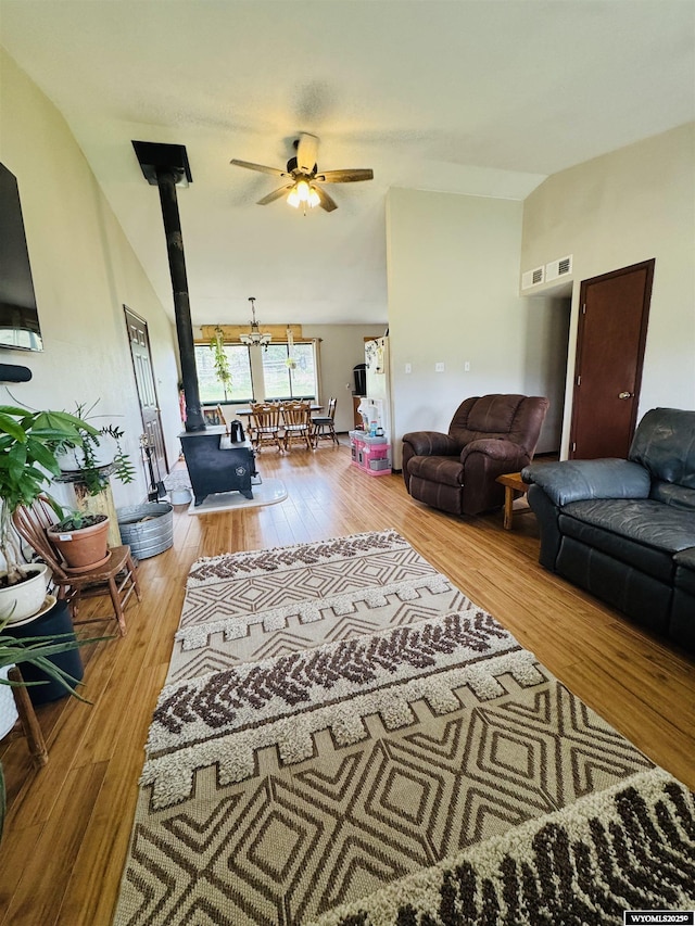 1512 Highview Dr, Dubois, WY 82513 - living room with a wood stove, a ceiling fan, hardwood / wood-style floors, and vaulted ceiling