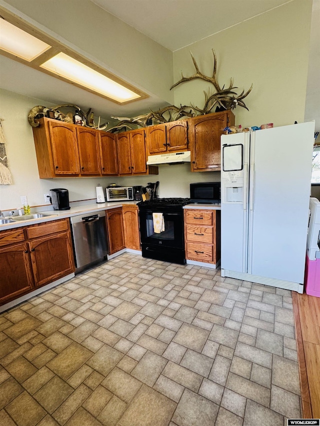 1512 Highview Dr, Dubois, WY 82513 - kitchen with dishwasher, white refrigerator with ice dispenser, black range with gas cooktop, under cabinet range hood, and brown cabinets