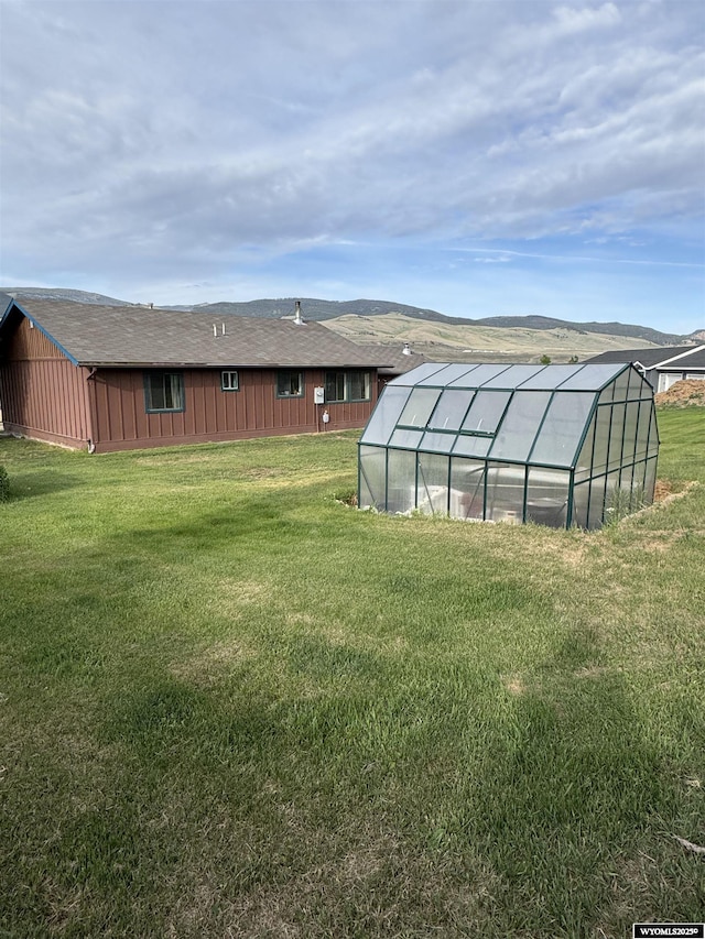 1512 Highview Dr, Dubois, WY 82513 - view of green lawn with an exterior structure and an outbuilding