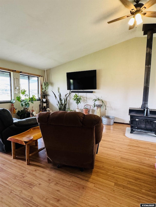 1512 Highview Dr, Dubois, WY 82513 - living room featuring a wood stove, lofted ceiling, ceiling fan, and light wood-style floors