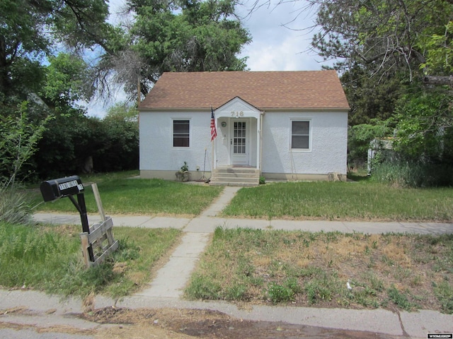 716 S 6th, Douglas, WY 82633 - bungalow-style house with a front lawn and stucco siding
