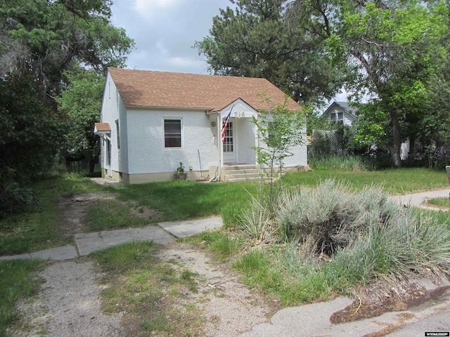 716 S 6th, Douglas, WY 82633 - bungalow-style home with stucco siding, roof with shingles, and entry steps