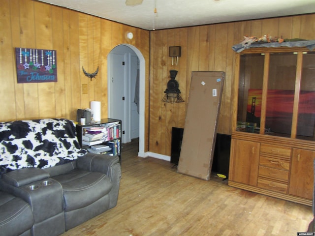 716 S 6th, Douglas, WY 82633 - living room with arched walkways, wood walls, light wood-type flooring, and ceiling fan