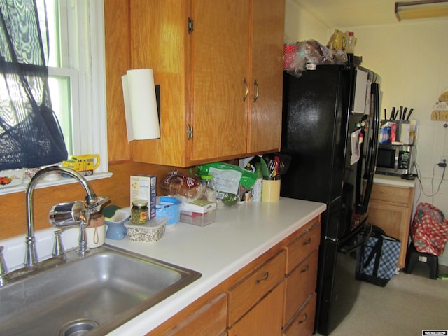 716 S 6th, Douglas, WY 82633 - kitchen with light countertops, stainless steel microwave, brown cabinets, and freestanding refrigerator