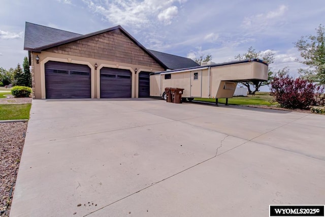 1011 Heritage Cove Dr, Lyman, WY 82937 - view of front of house featuring driveway, a garage, and roof with shingles