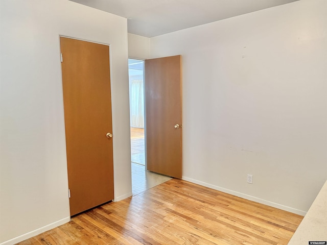 422 Beech Ave, Kemmerer, WY 83101 - spare room with light wood-style floors and baseboards