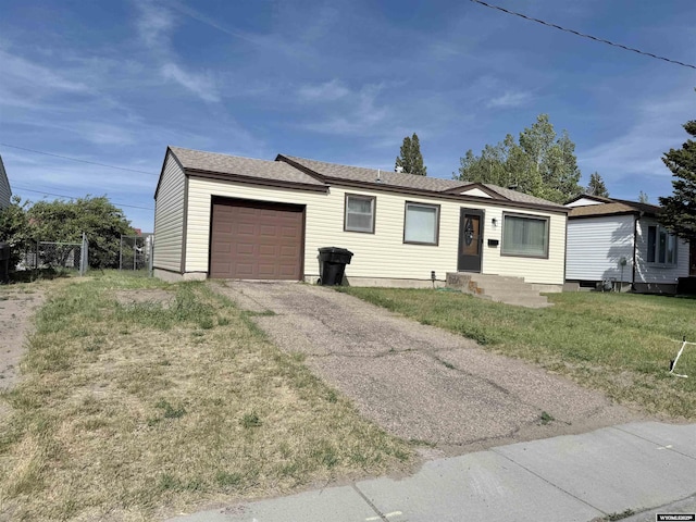 422 Beech Ave, Kemmerer, WY 83101 - ranch-style house with an attached garage and asphalt driveway