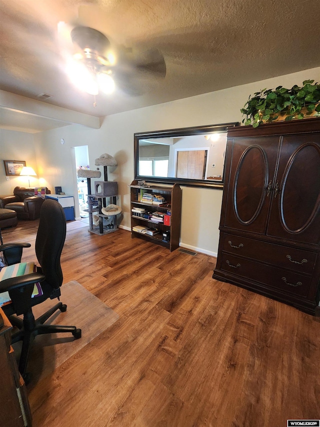 828 Fort St, Buffalo, WY 82834 - office space featuring ceiling fan, wood finished floors, and a textured ceiling