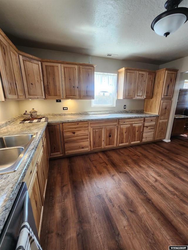 828 Fort St, Buffalo, WY 82834 - kitchen with dark wood-style floors, light countertops, a textured ceiling, and dishwasher