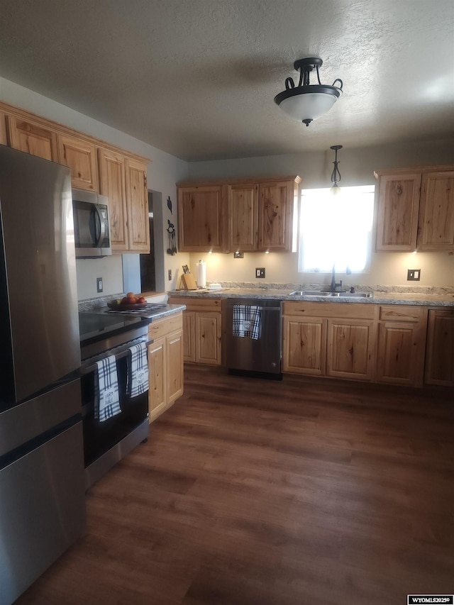 828 Fort St, Buffalo, WY 82834 - kitchen with stainless steel appliances, dark wood-style floors, and a textured ceiling