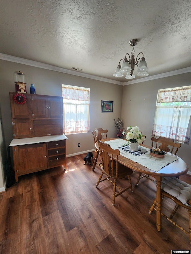 828 Fort St, Buffalo, WY 82834 - dining room featuring a textured ceiling, dark wood-style flooring, a chandelier, and crown molding