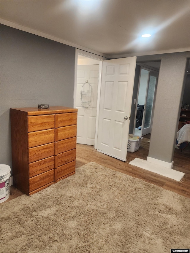 828 Fort St, Buffalo, WY 82834 - bedroom featuring wood finished floors, ornamental molding, and recessed lighting