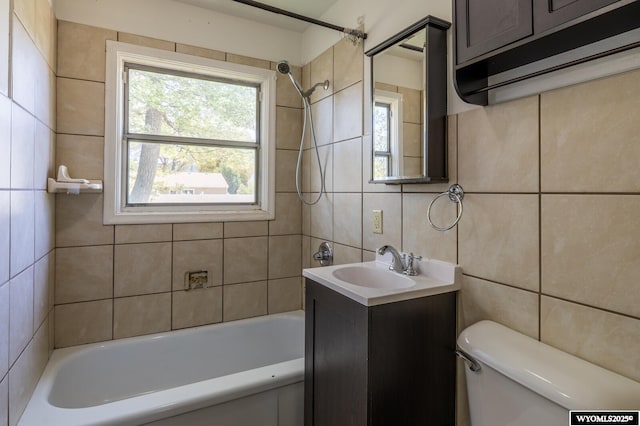 2841 E 4th St, Casper, WY 82609 - bathroom featuring tile walls, vanity, washtub / shower combination, and tasteful backsplash