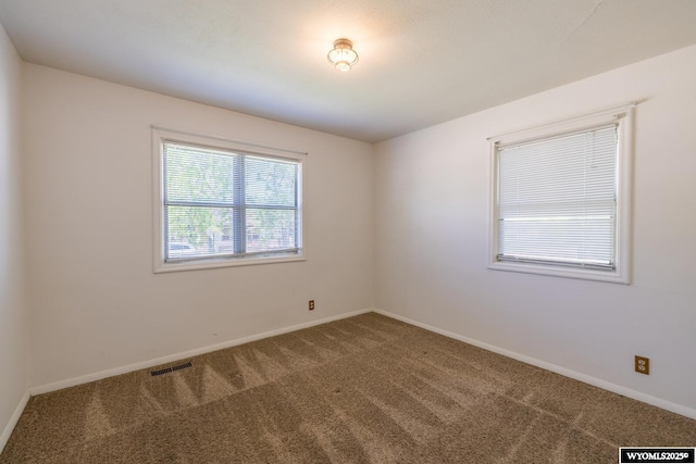 2841 E 4th St, Casper, WY 82609 - carpeted spare room featuring baseboards