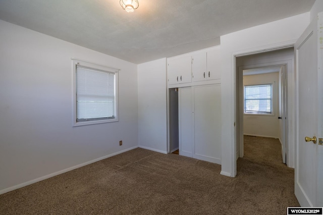 2841 E 4th St, Casper, WY 82609 - unfurnished bedroom featuring dark carpet and a closet