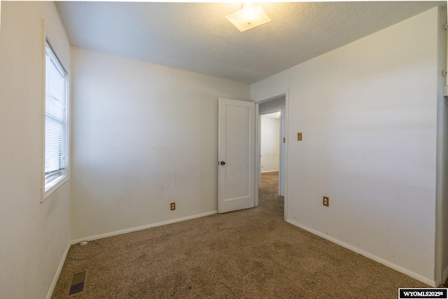 2841 E 4th St, Casper, WY 82609 - carpeted spare room featuring baseboards and a textured ceiling