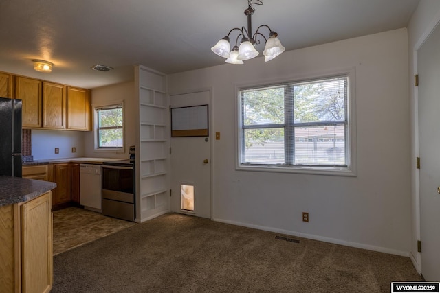 2841 E 4th St, Casper, WY 82609 - kitchen with stainless steel electric stove, dishwasher, freestanding refrigerator, and carpet floors