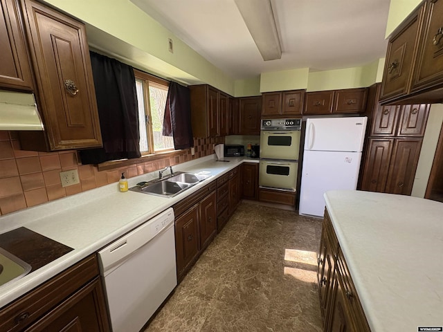 1501 N Federal Blvd, Riverton, WY 82501 - kitchen with white appliances, light countertops, tasteful backsplash, dark brown cabinets, and under cabinet range hood